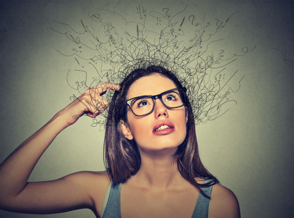 Closeup portrait young woman scratching head, thinking daydreaming with brain melting into lines question marks looking up isolated on gray background. Human facial expressions, emotion feeling sign