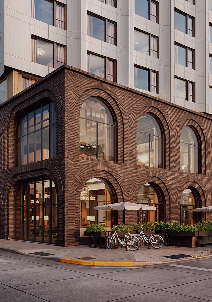 Brown building on the corner of the street with bicycles parked out front