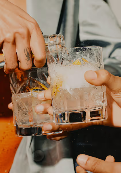 Hands holding cocktails. Photo by Fanette Guilloud