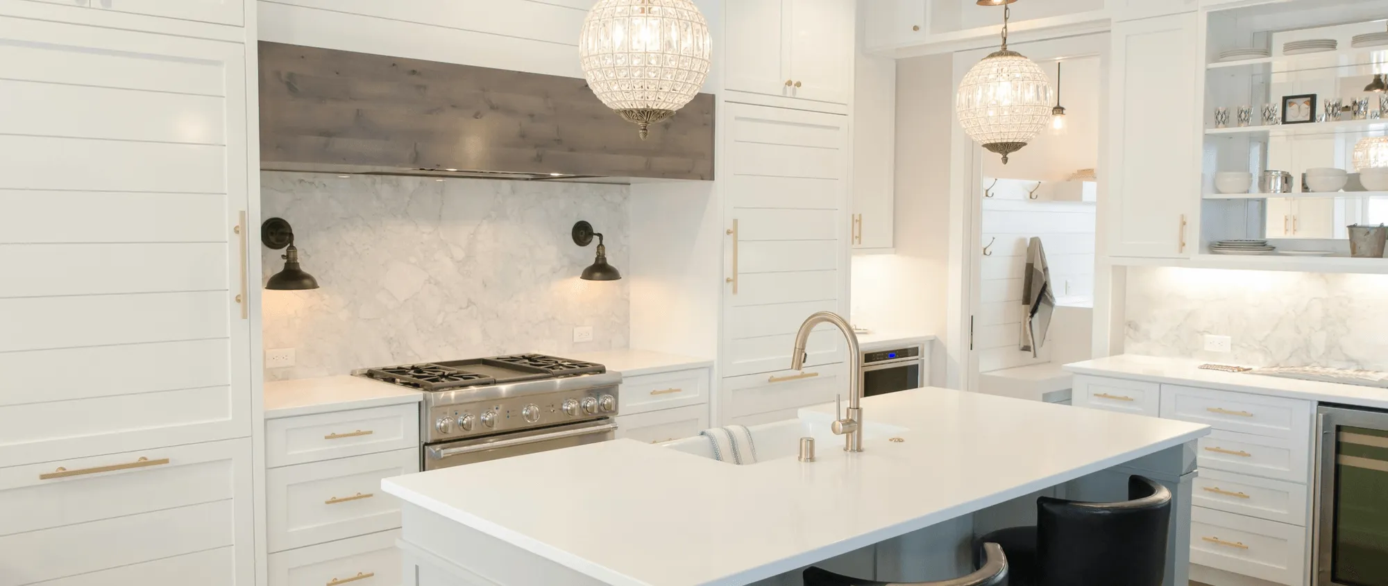 A newly upgraded white kitchen with marble countertops and white cabinets