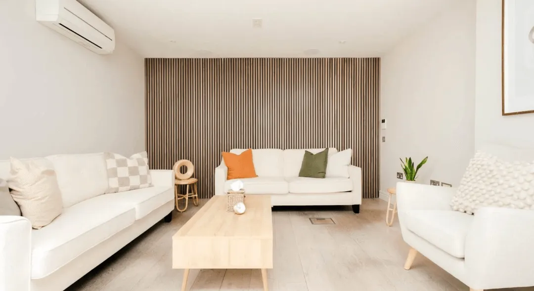 A therapy room with a white couch and a wooden coffee table in front of it.