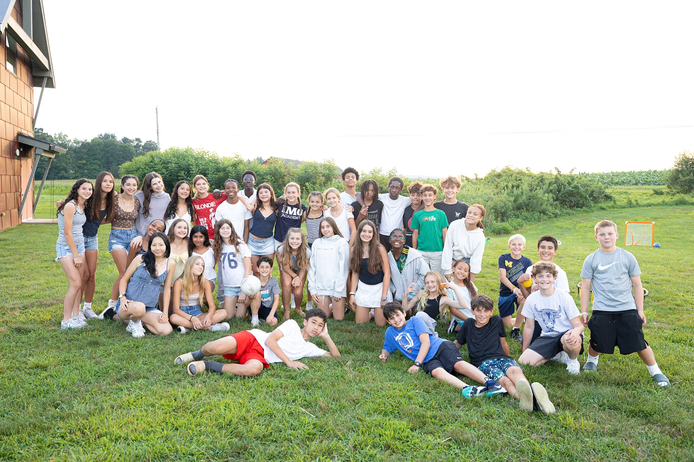 Youth athletes practicing teamwork at camp