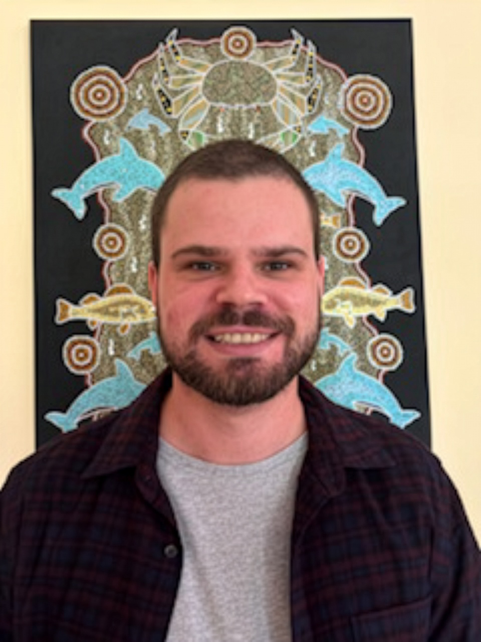 Kyle Johnson standing in front of a painting