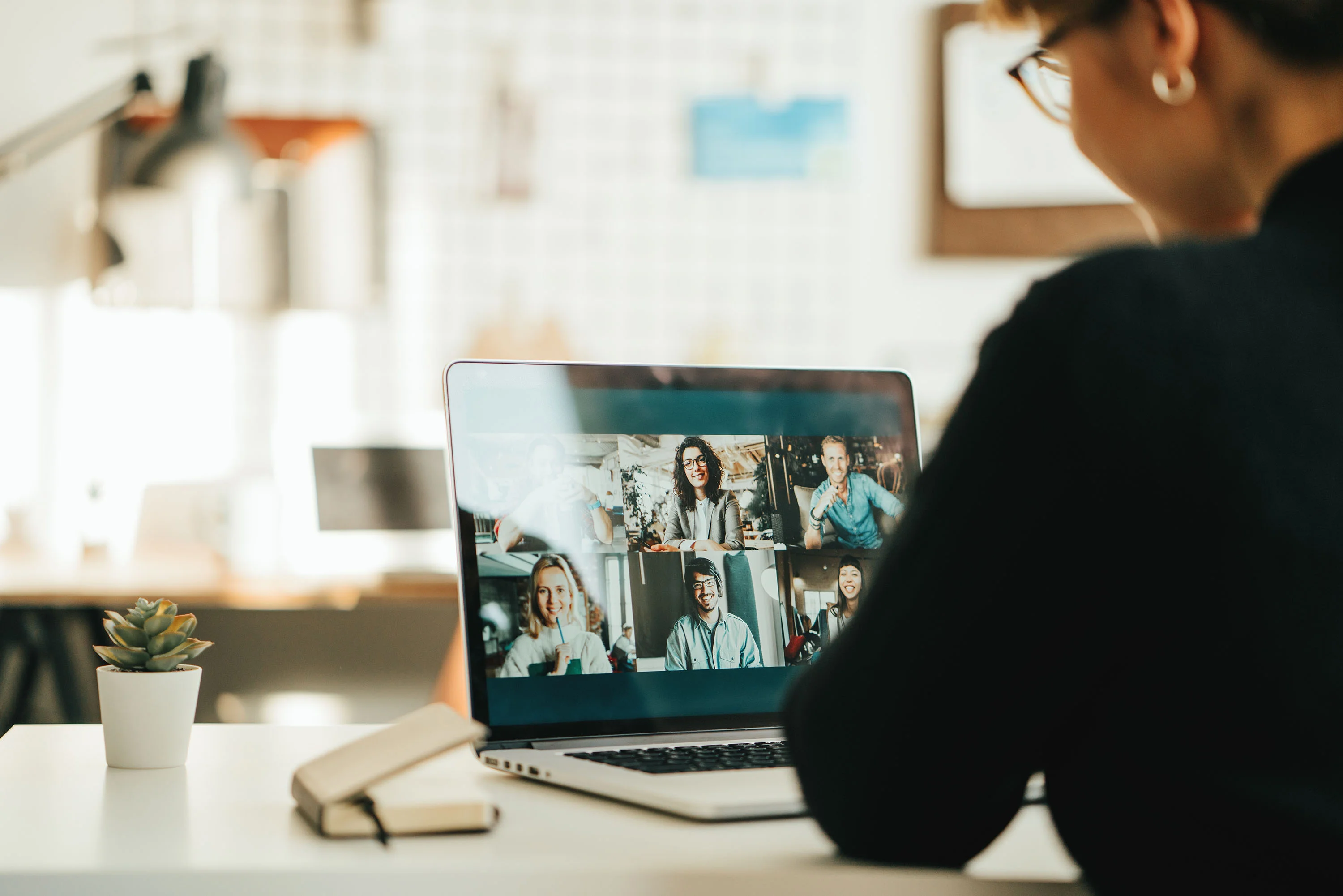 Woman sitting in front of laptop, having a meeting