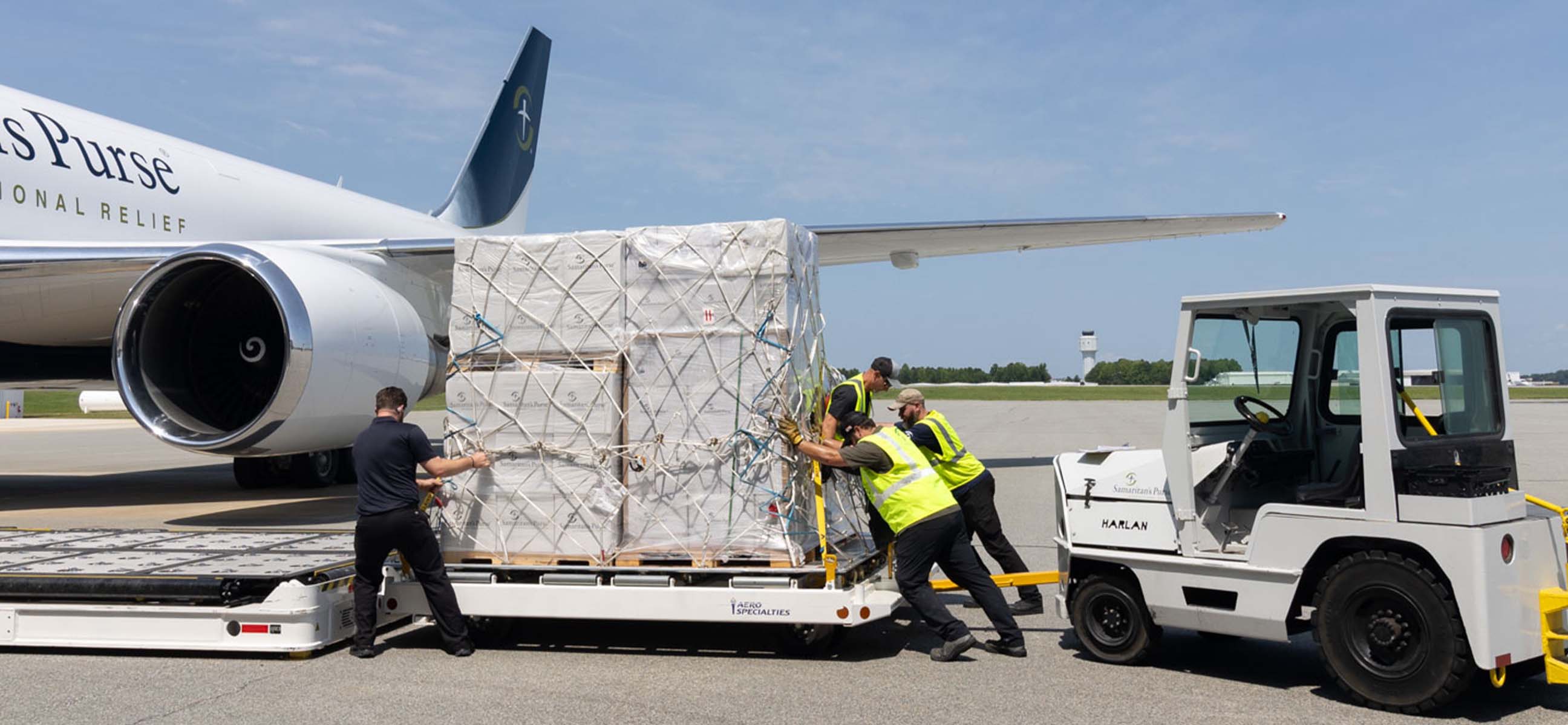 Workers load a pallet of relief supplies onto a Samaritan's Purse cargo plane.