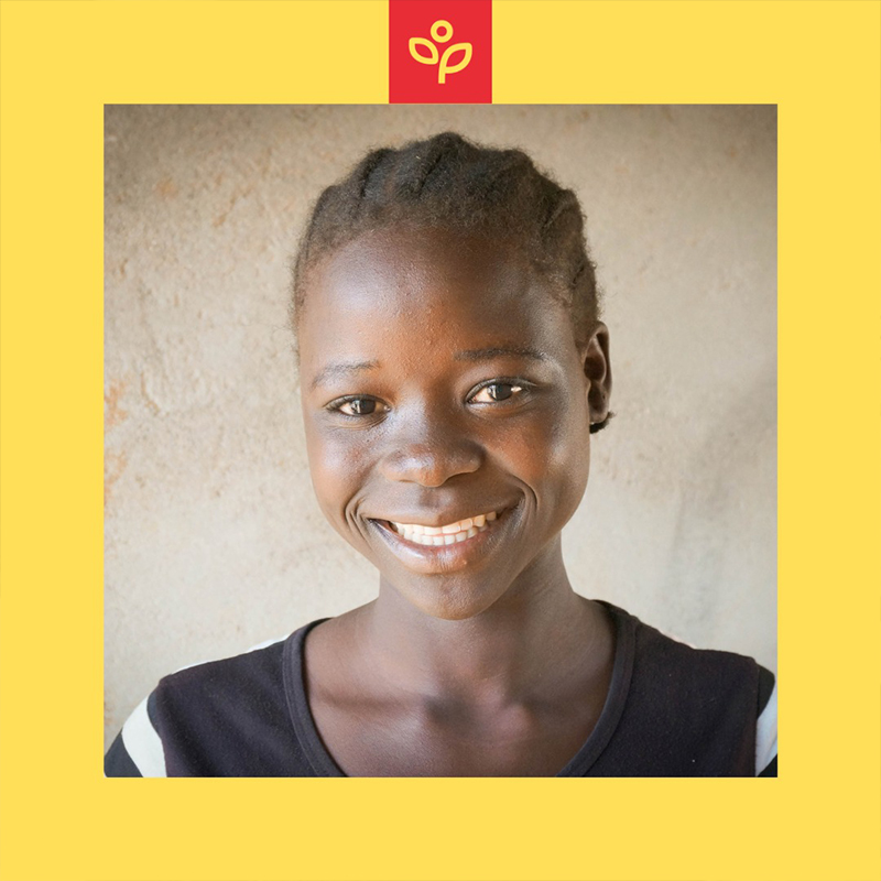 A smiling young woman against a yellow background, with the Lift Up the Vulnerable logo above her.