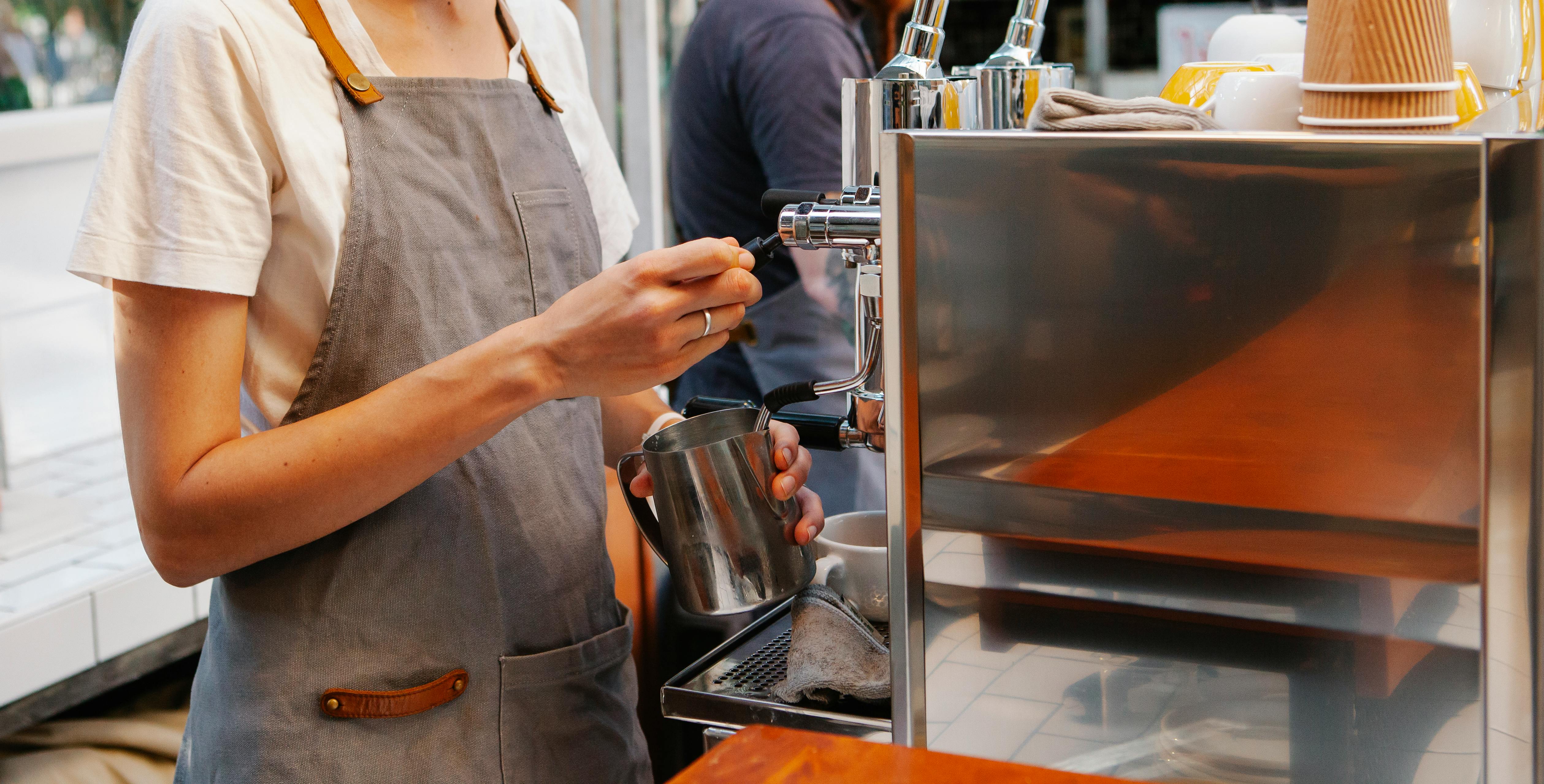 Barista preparing drinks at an espresso machine