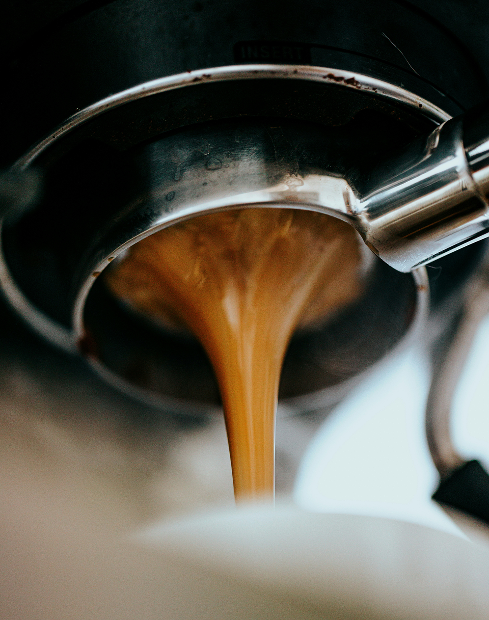 Espresso extracting into a cup