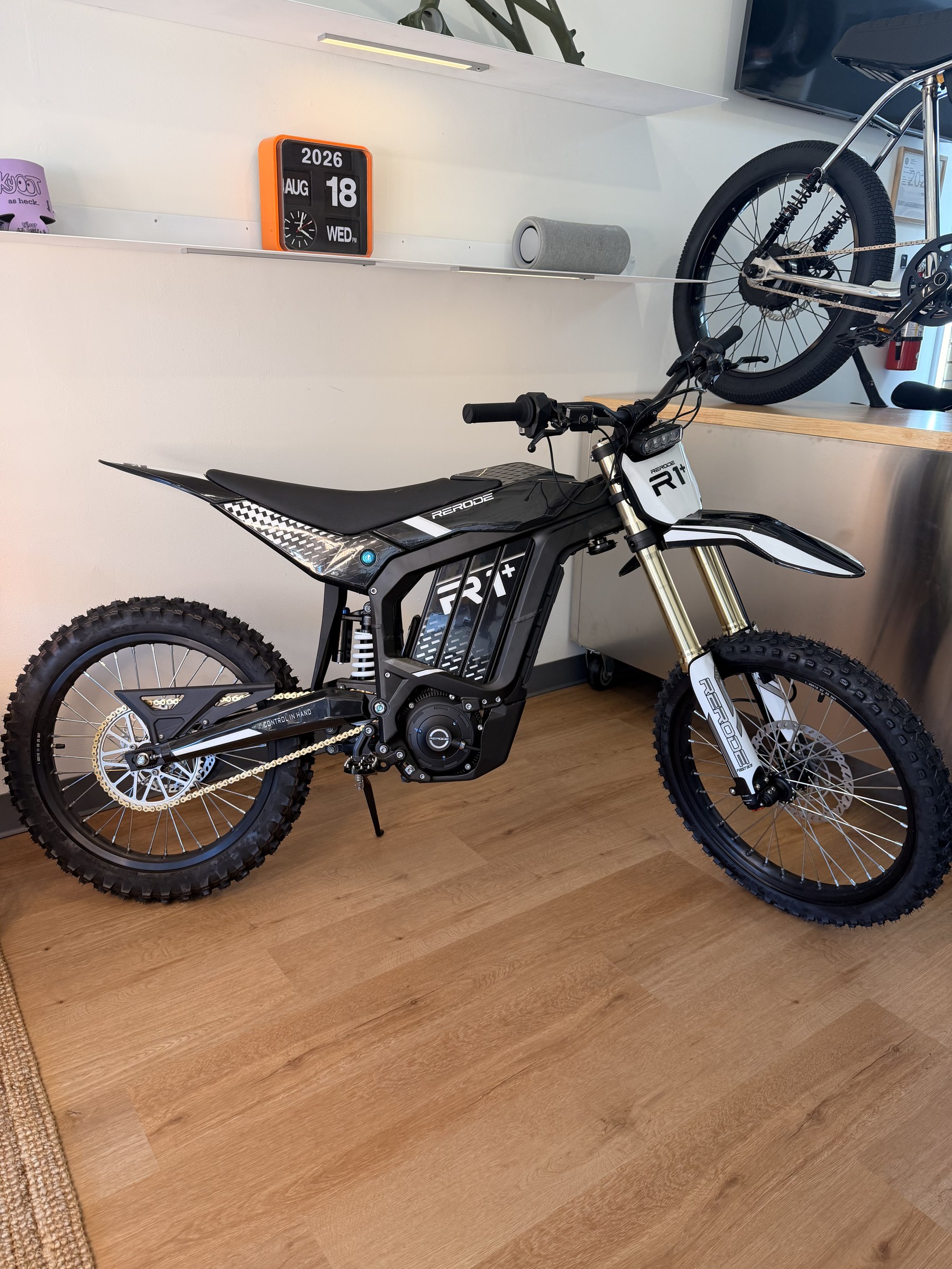 Rerode R1+ electric dirt bike, rear three-quarter view showing battery pack and swingarm