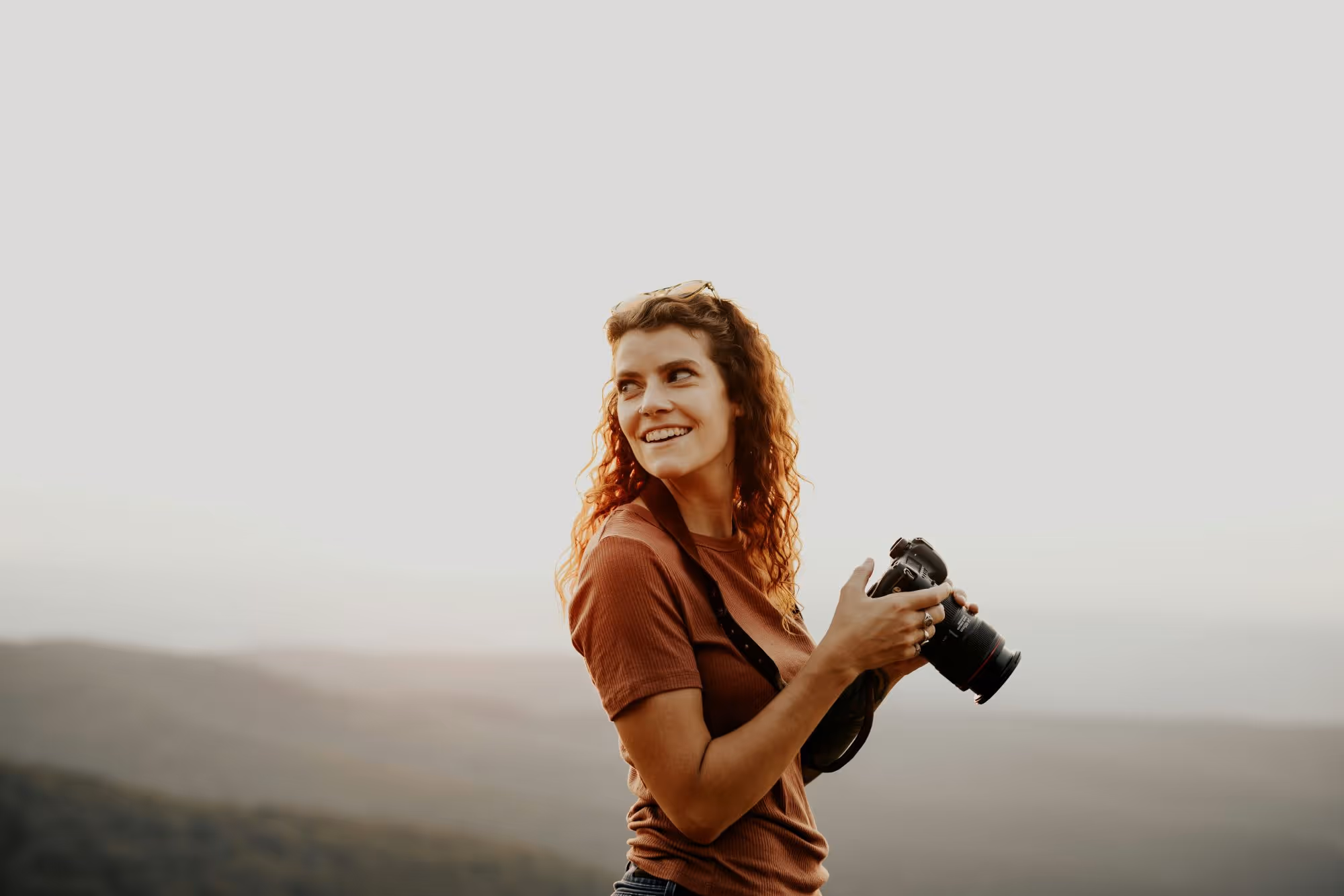 A woman with a camera in the nature