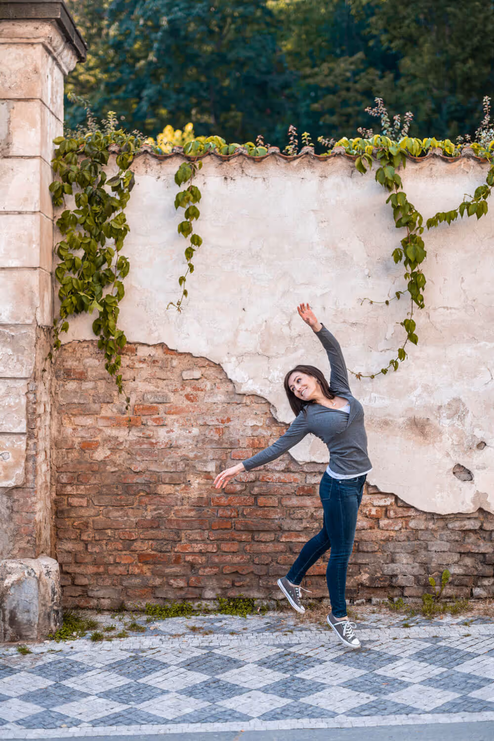 Juliann Beals - A UX Website Designer - dancing on a cobblestone street in Prague. 