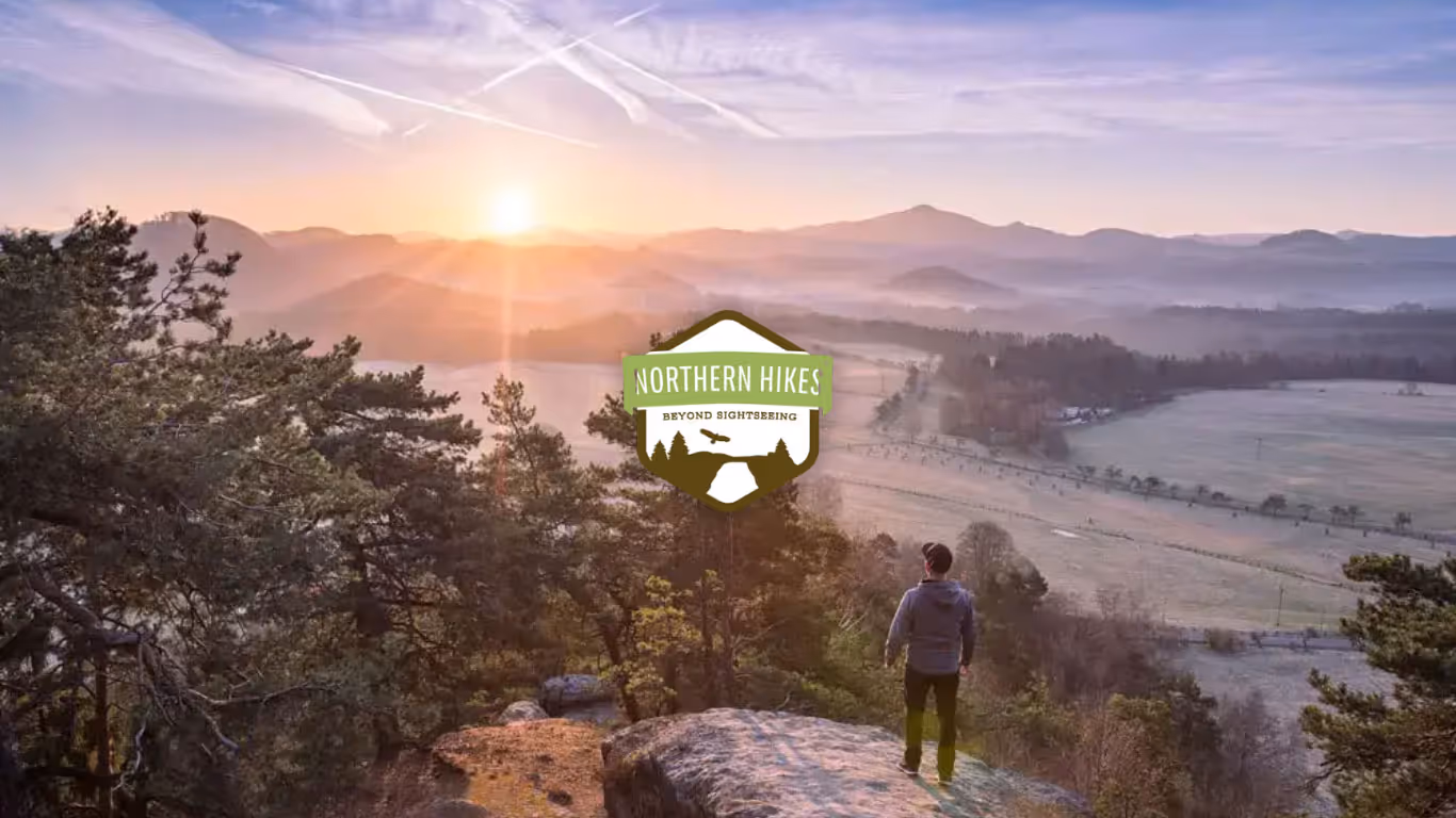 A cover image for an adventure website design showcasing a man standing at a viewpoint in the Czechia nature. 