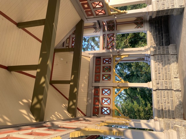 Historic pavilion interior with custom decorative millwork and exposed wood beams