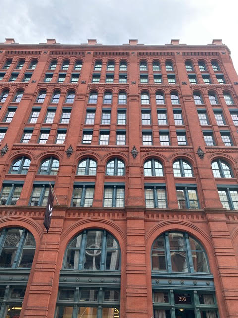 Historic landmark red brick building with arched windows and detailed facade