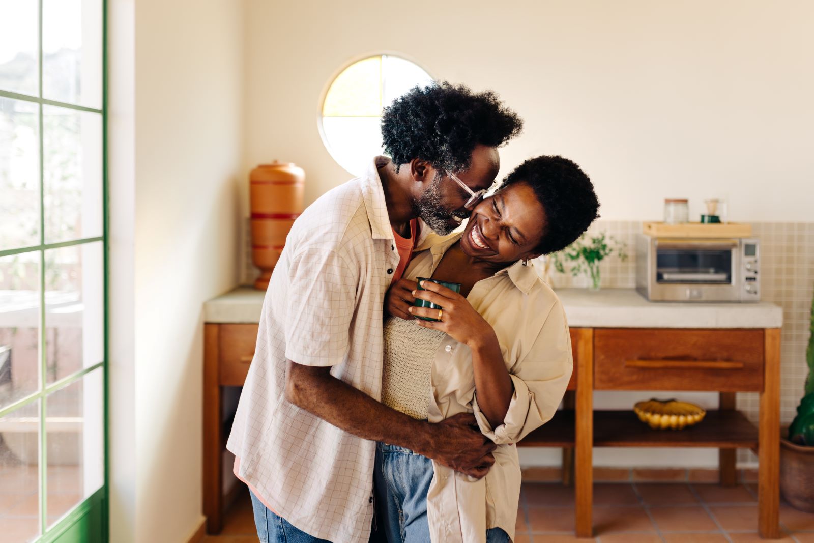 A man and a woman standing in a kitchen.