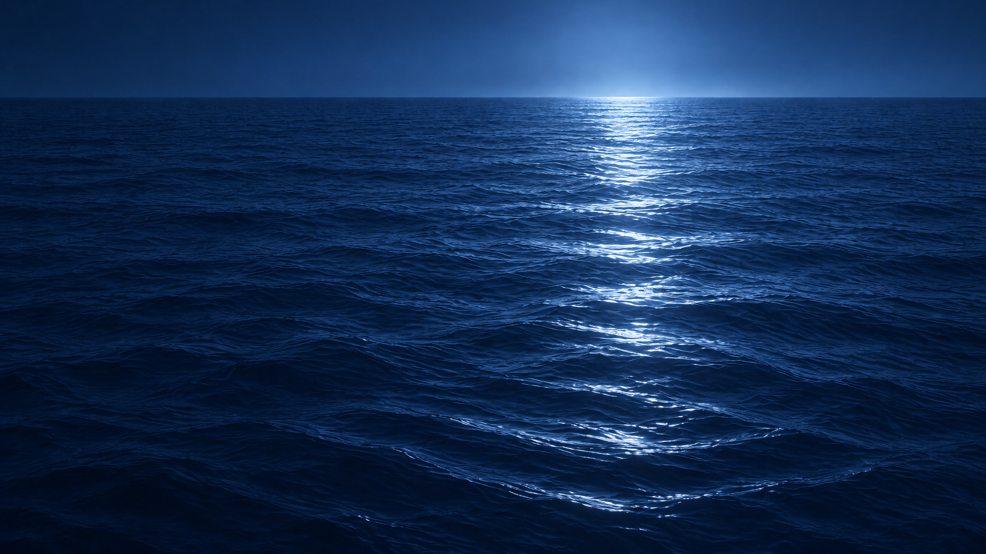 A broad moonlit path over navy water toward the horizon