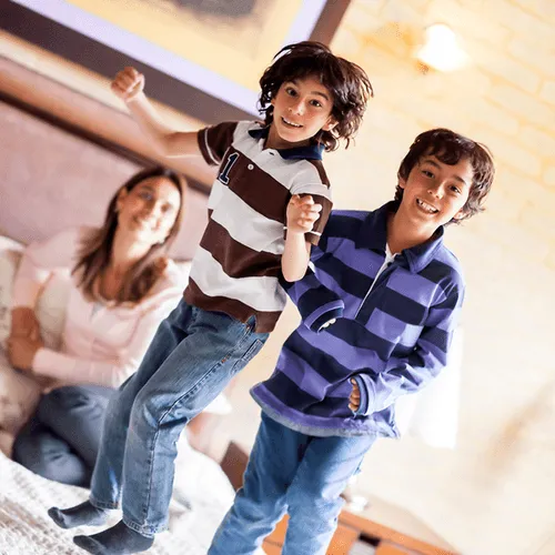 Kids jumping on bed