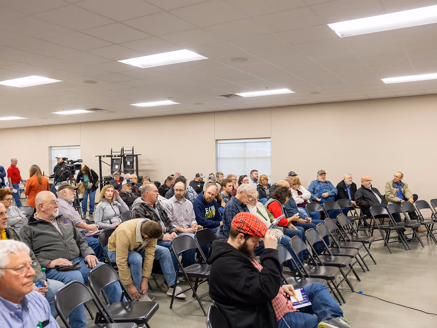 Room of people sitting on chairs