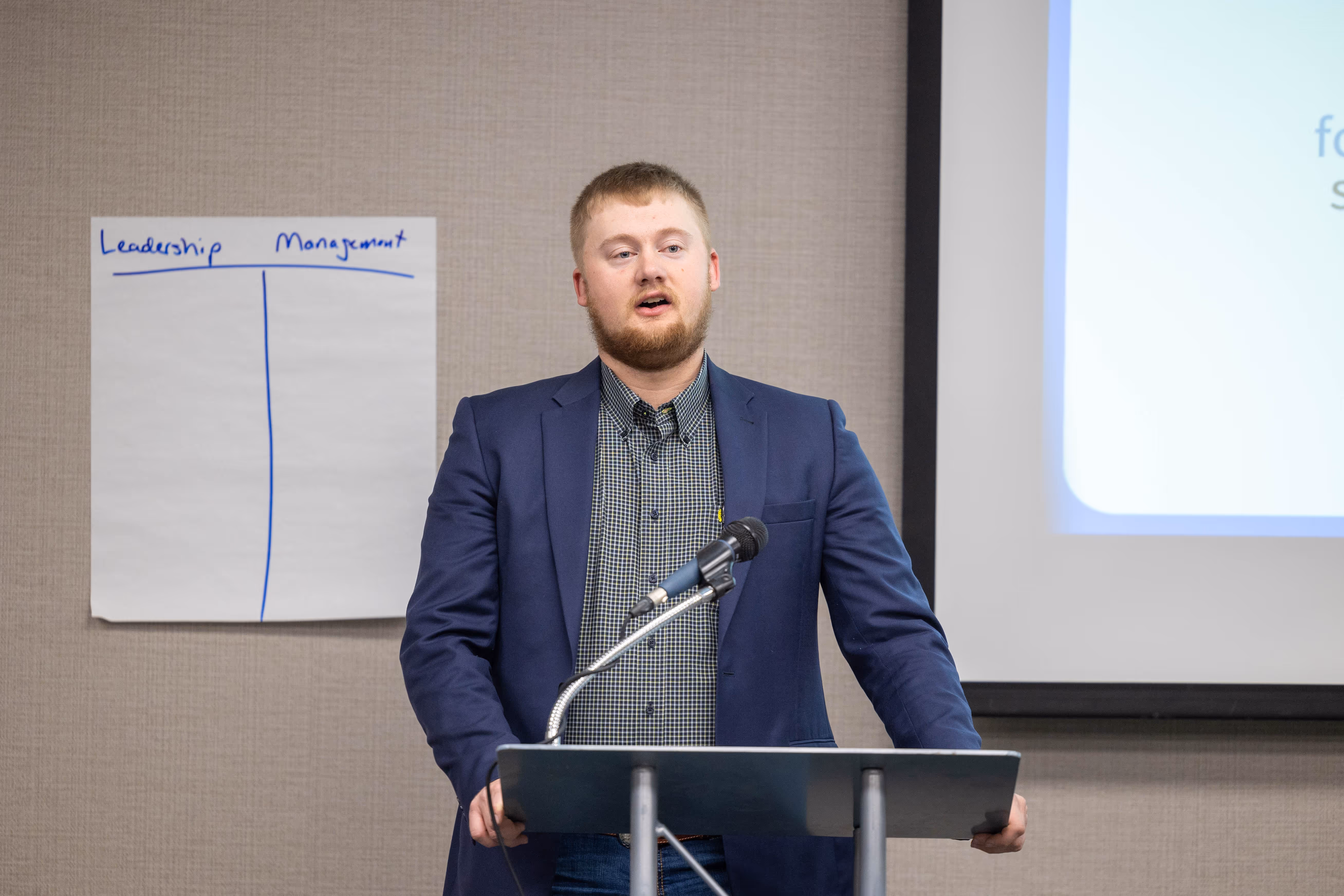 Man standing and speaking at a podium