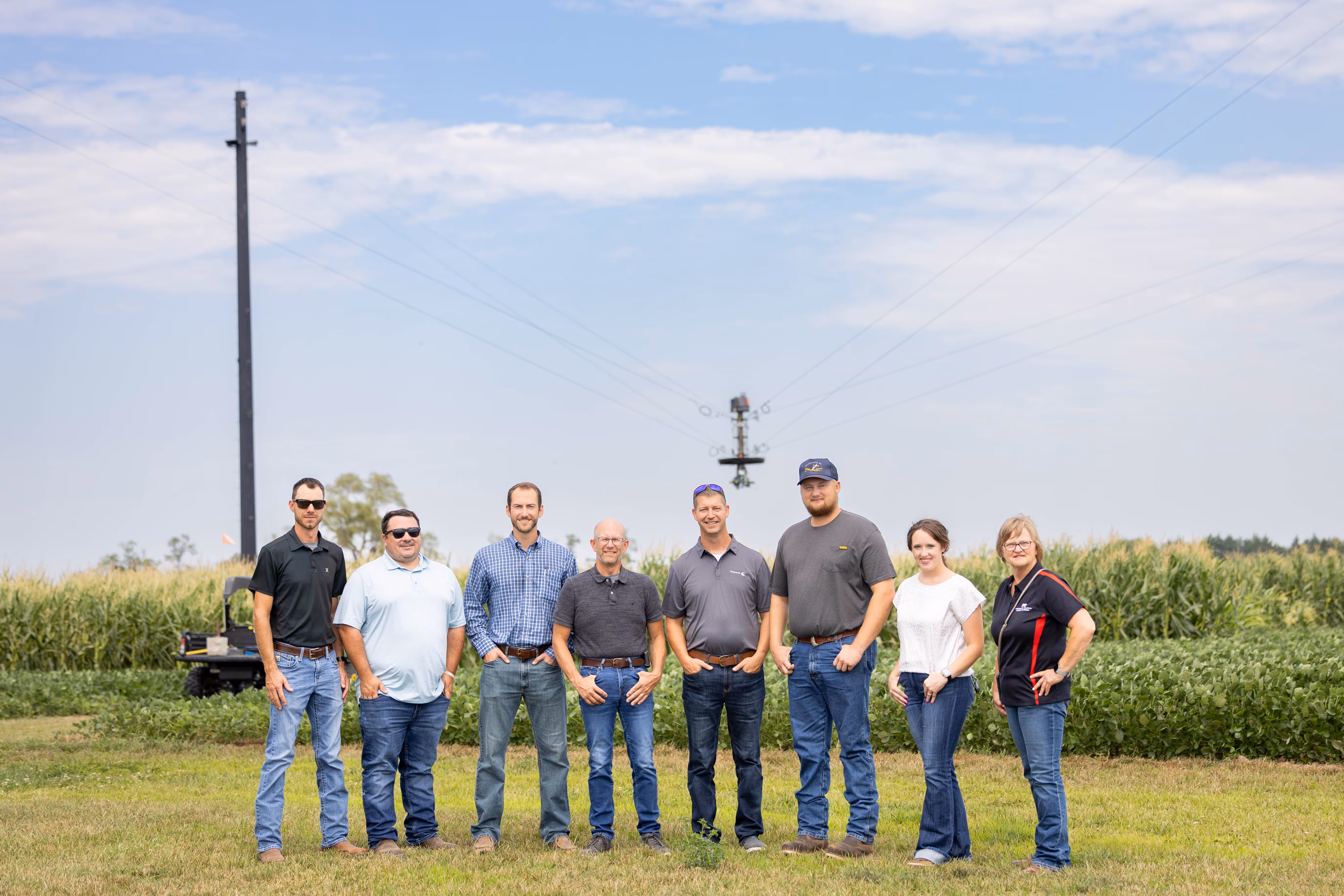 Group of people standing in front of a field