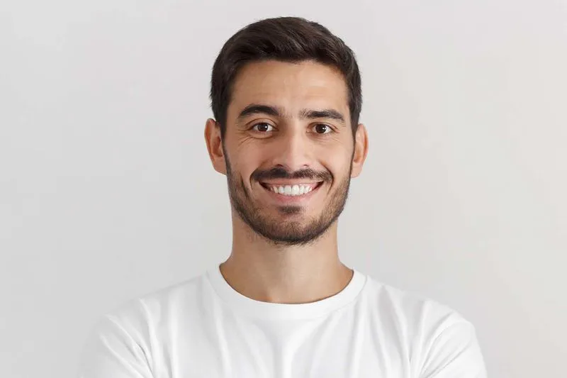 A man with a goatee smiles at the camera.