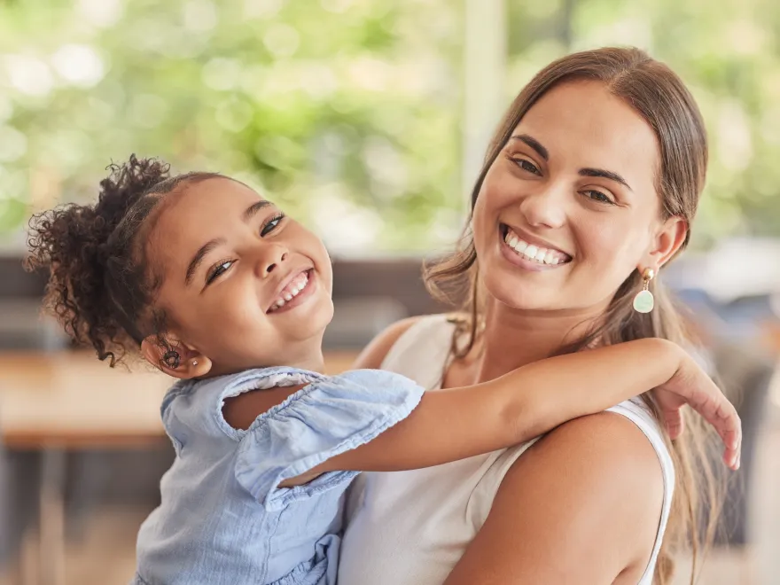 A woman holding a small child in her arms.