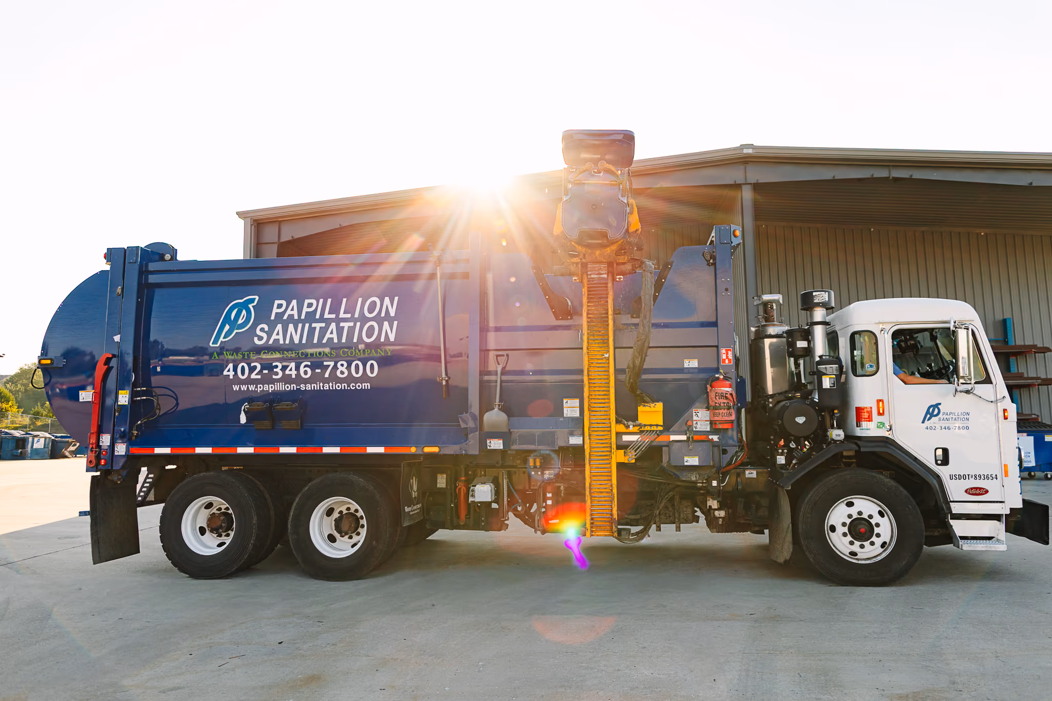 Residential side-load collection truck used for curbside waste pickup