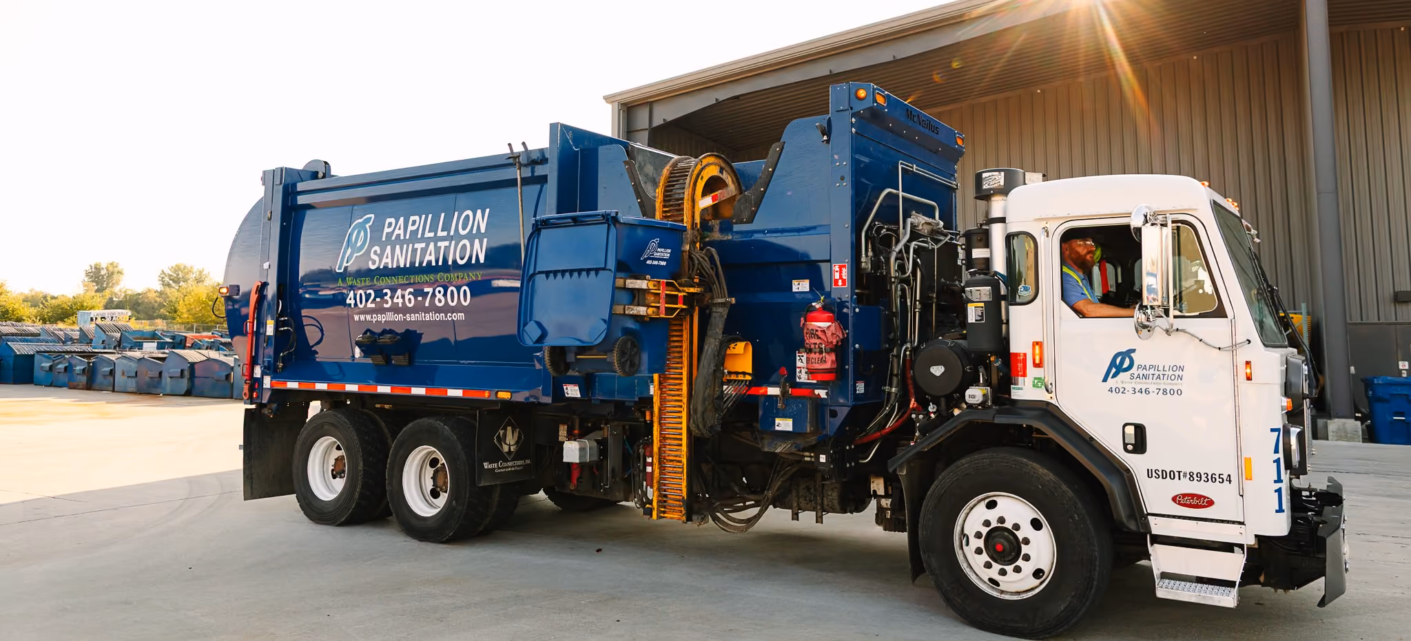Residential side-load truck used for curbside waste and recycling pickup