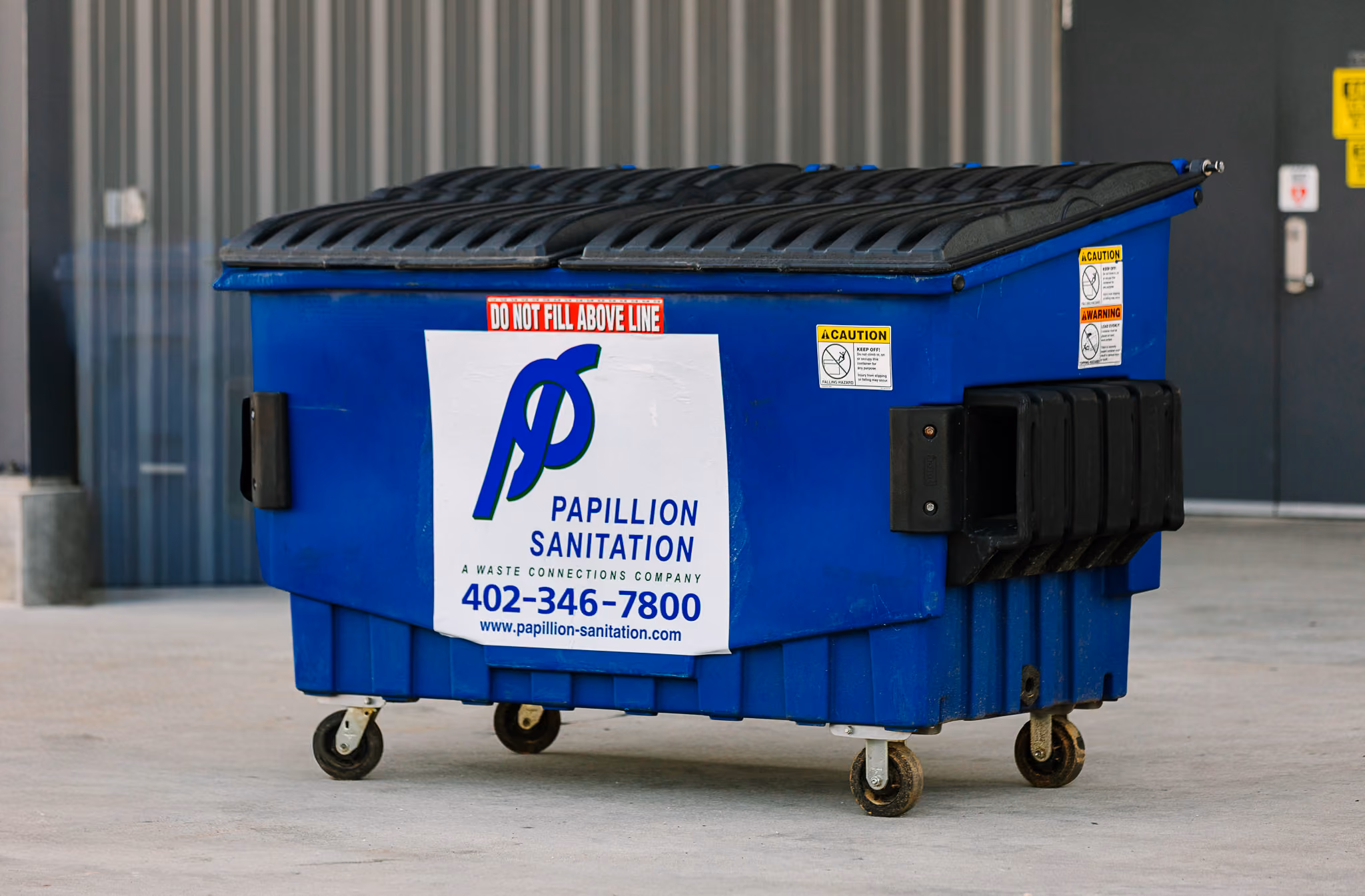 Commercial dumpster positioned outside a business for waste collection services