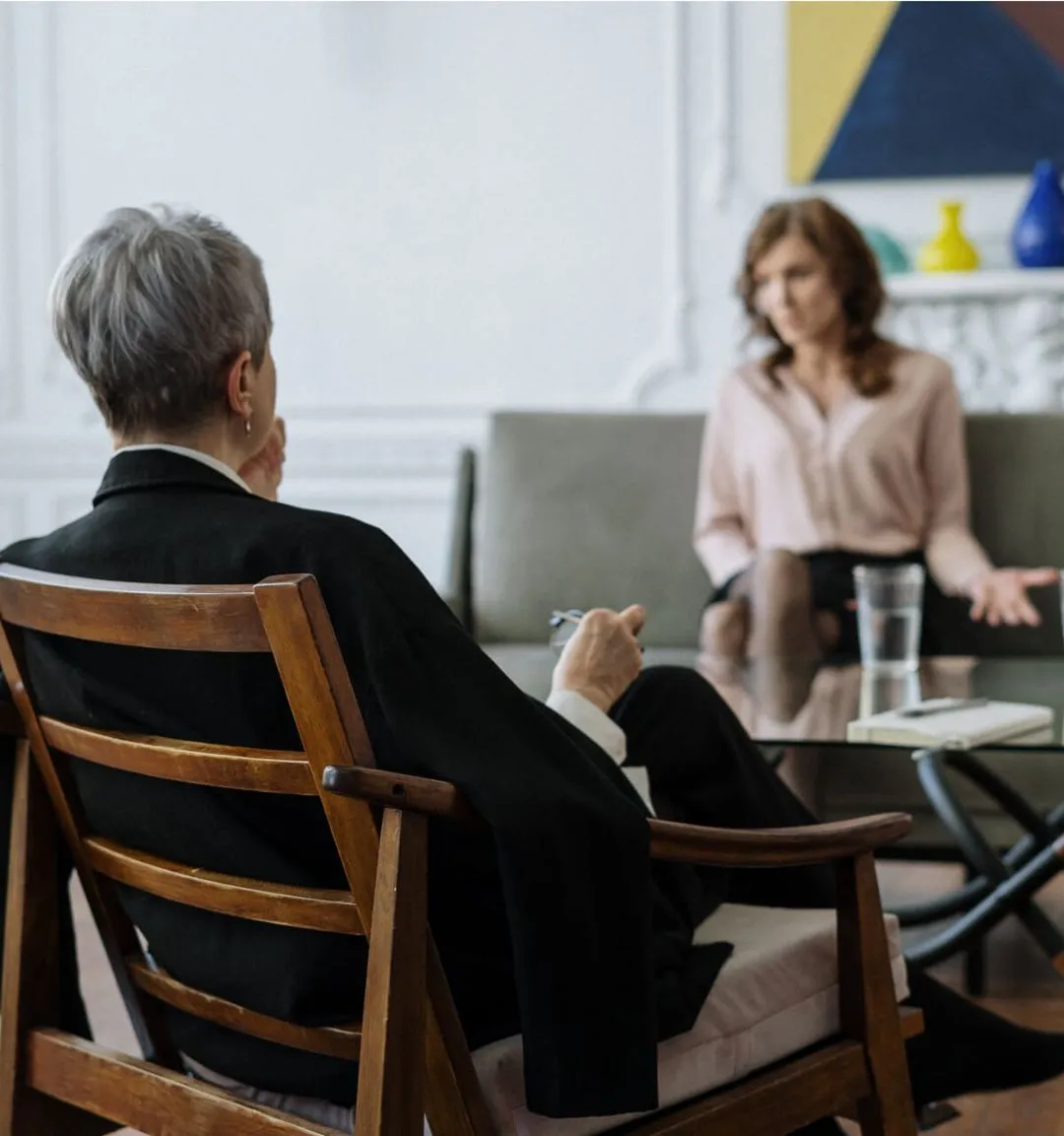 persons having a talk in living room