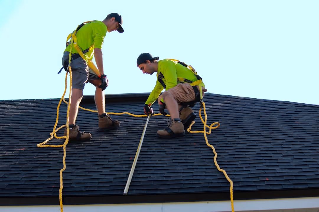 Professional crew installing a TPO membrane on a flat roof - commercial roof installation