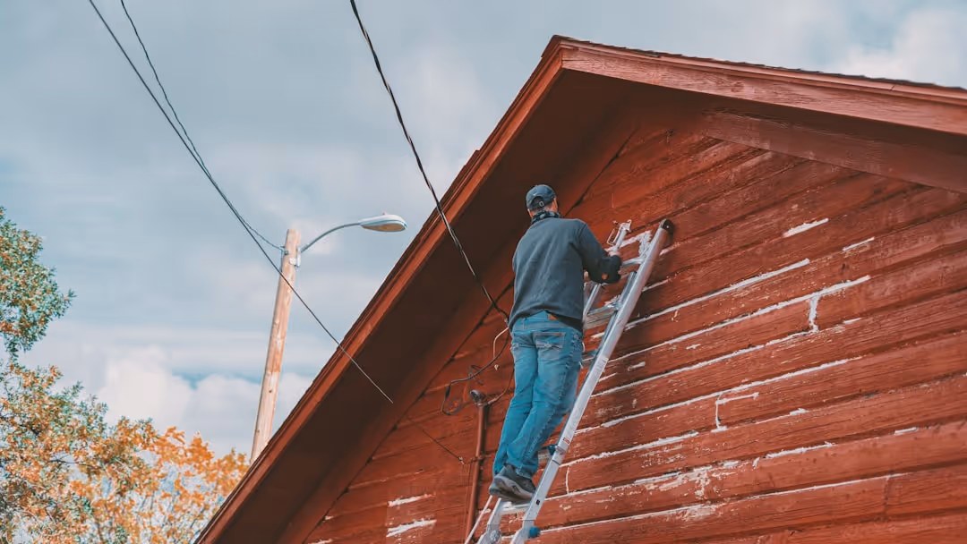 Professional siding installers working on a home in Port Washington - house siding replacement cost