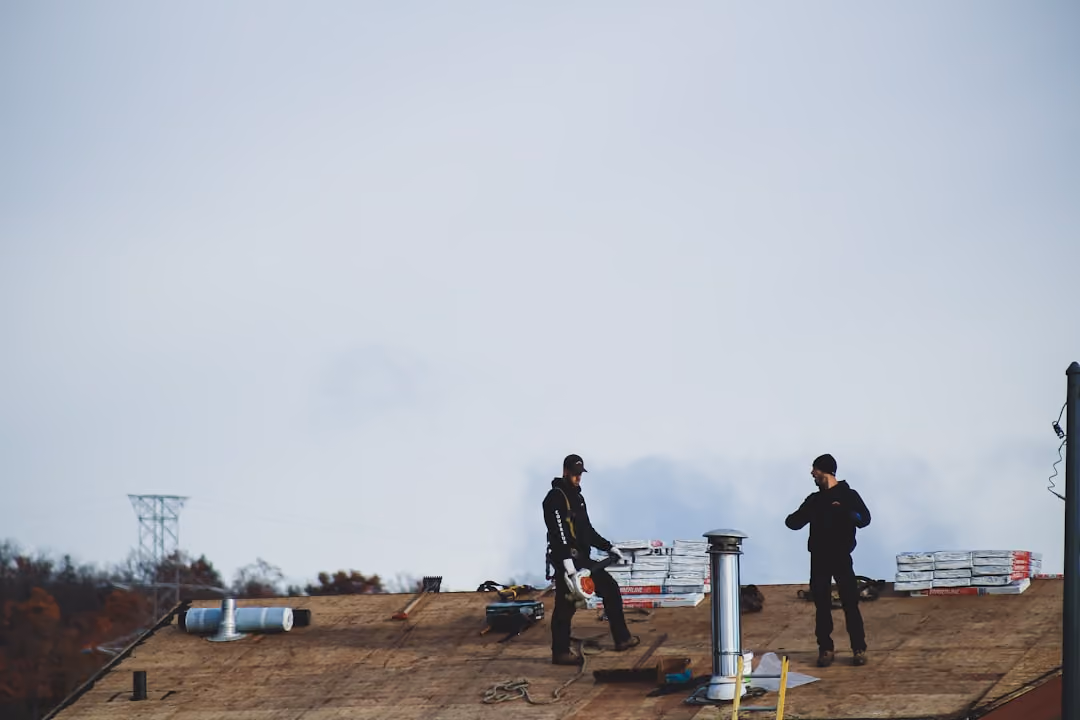 commercial roofers on top of building - choose the best commercial roof installation contractor in Long Island & Queens. Expert TPO, EPDM installs, GAF certified, local pros for durable roofs concept