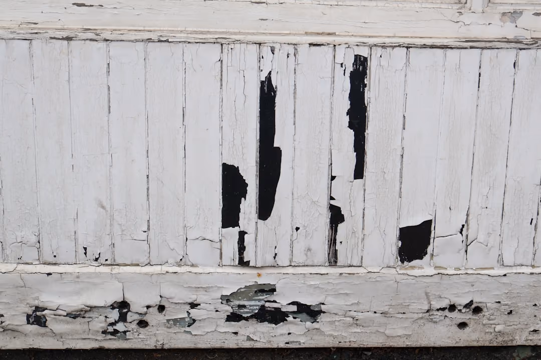 Warped and cracked siding panels showing clear signs of moisture damage and age - long island siding replacement Warped and cracked siding panels showing clear signs of moisture damage and age - long island siding replacement
