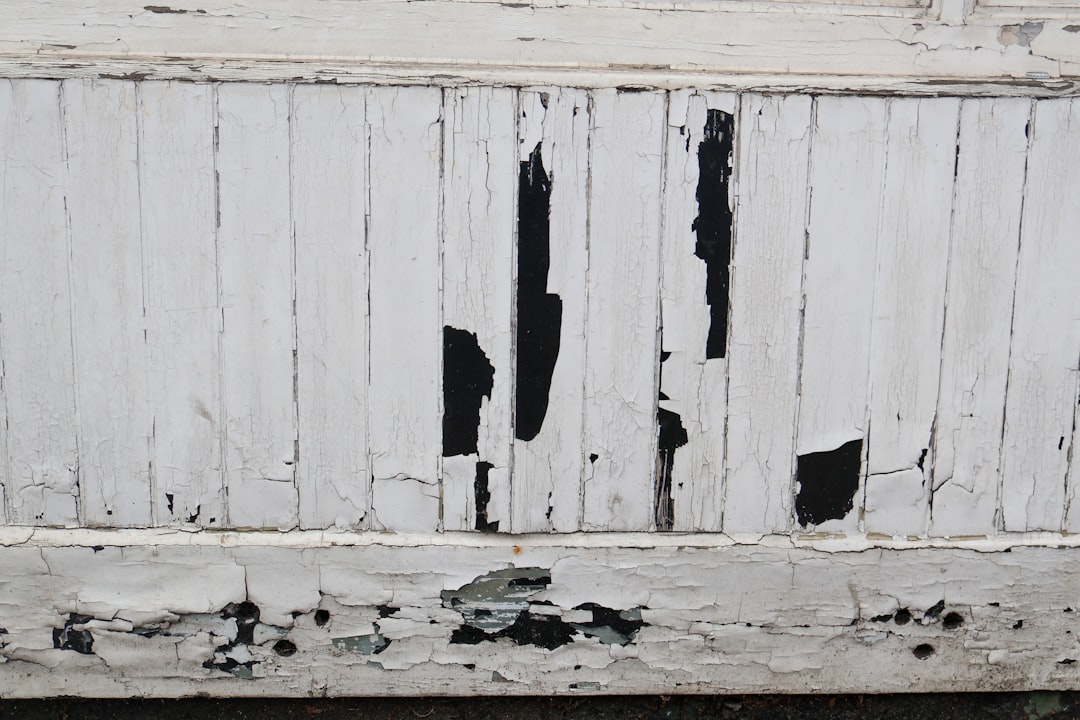 Warped and cracked siding panels showing clear signs of moisture damage and age - long island siding replacement Warped and cracked siding panels showing clear signs of moisture damage and age - long island siding replacement