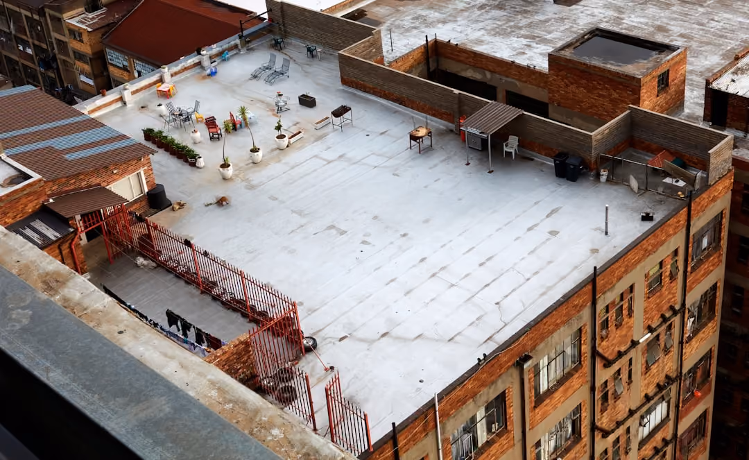 flat roof in winter with snow accumulation and drainage scuppers - industrial flat roofing