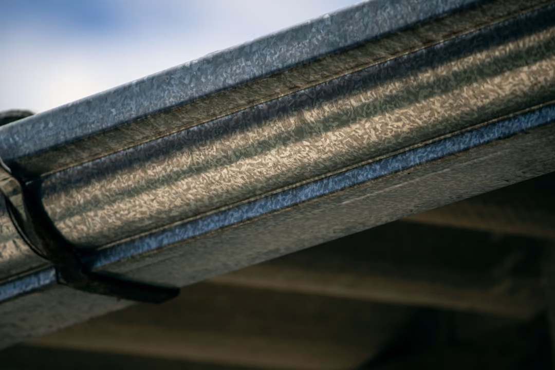 closeup of gutter on house - gutter cost per linear foot installed