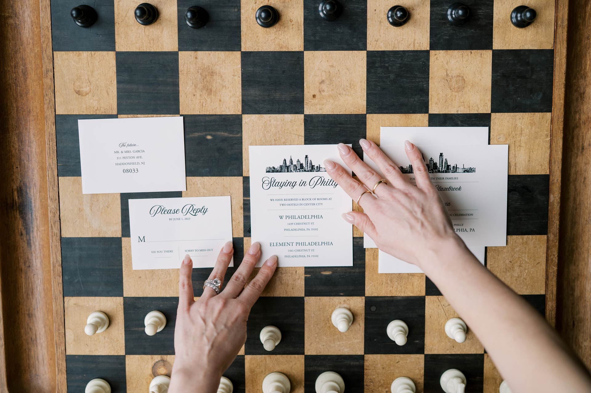 Modern Philadelphia wedding invitation suite styled on a vintage chessboard with black and white pieces