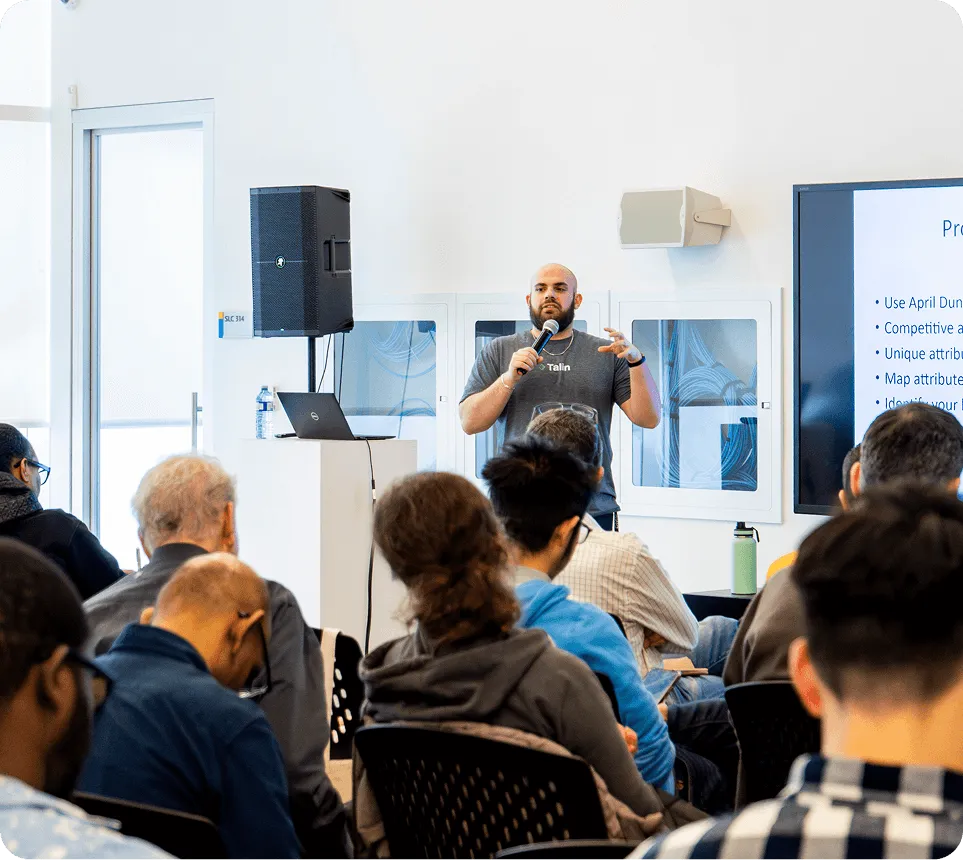 Instructor leading a housing innovation workshop to a room of adult learners, showcasing DMZ’s Skills Academy training program for founders and professionals in the housing and manufacturing sectors.