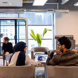 Startup founders in a workspace, reflecting DMZ’s custom-designed startup programs aligned with community goals.
