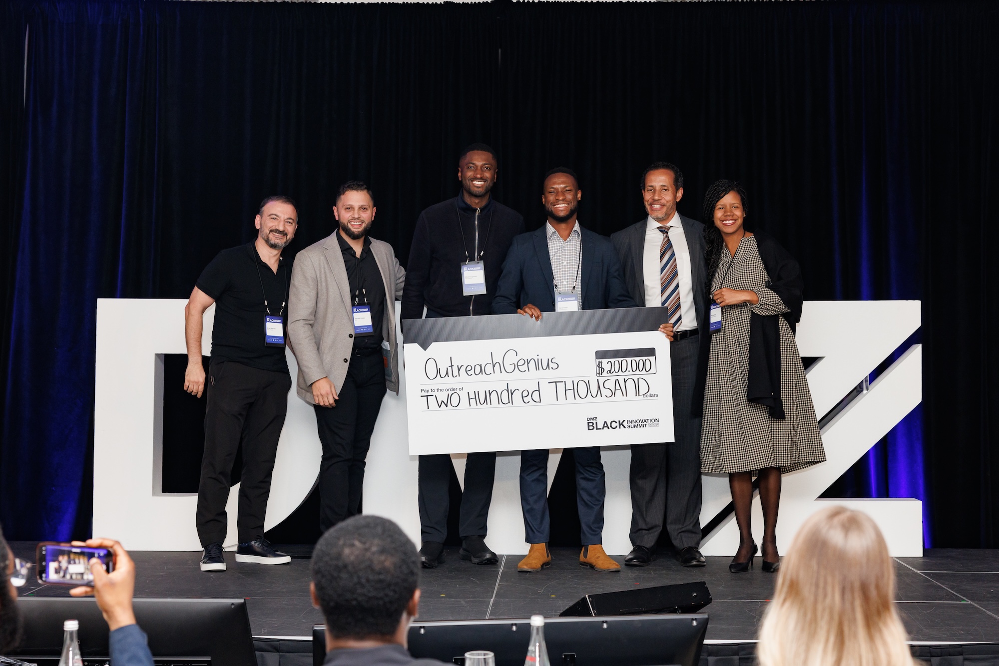 Two smiling Black women attendees at DMZ’s Black Innovation Summit 2025, celebrating Black excellence in tech through trailblazing conversations and powerful community-building.