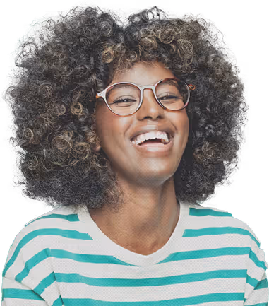 Smiling woman with curly hair and glasses wearing a green and white striped shirt.