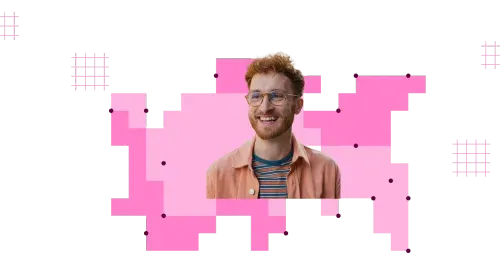 Smiling man with curly red hair and beard wearing glasses, a striped shirt, and a peach jacket with pink graphic background.