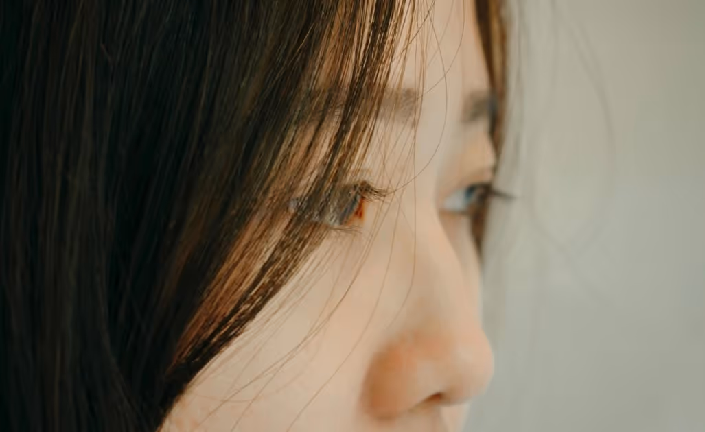 Close-up of a woman of color's eyes, conveying introspection and emotional depth.