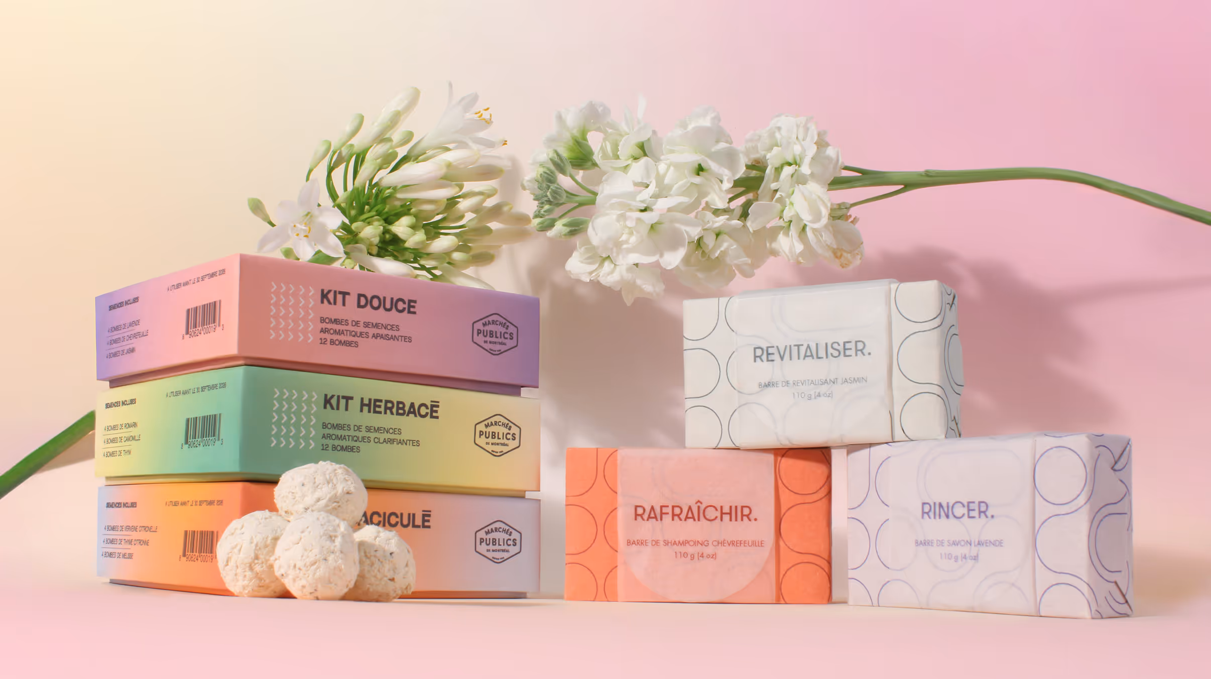 Hero shot of seed bomb and shower bar skits, surrounded by flowers.