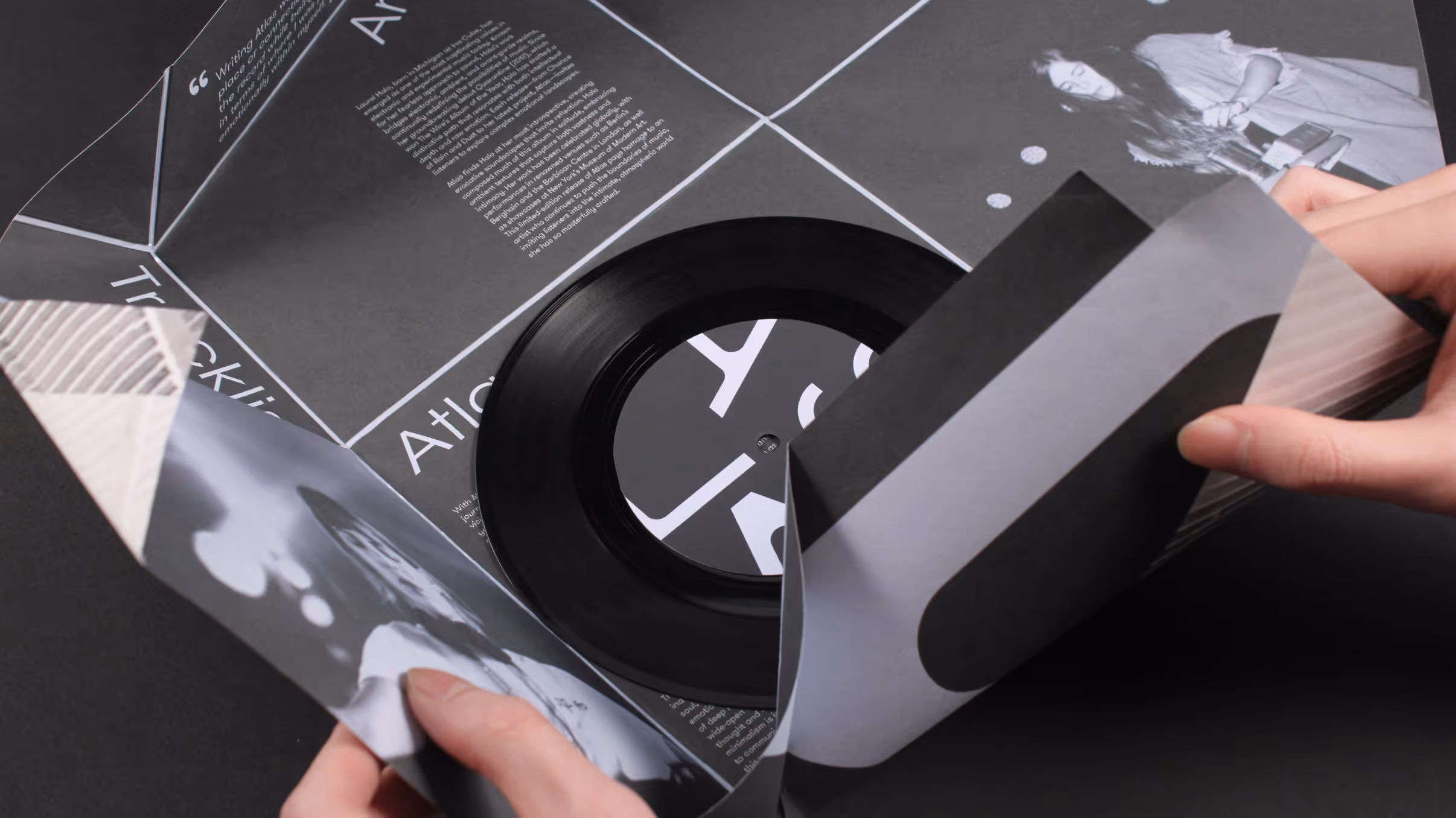 Closeup of vinyl packaging being unfolded into a poster with vinyl inside.