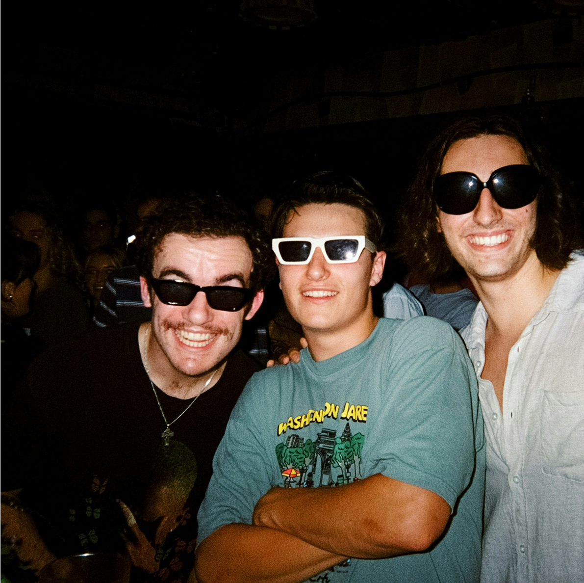 Friends at a party posing for a picture.