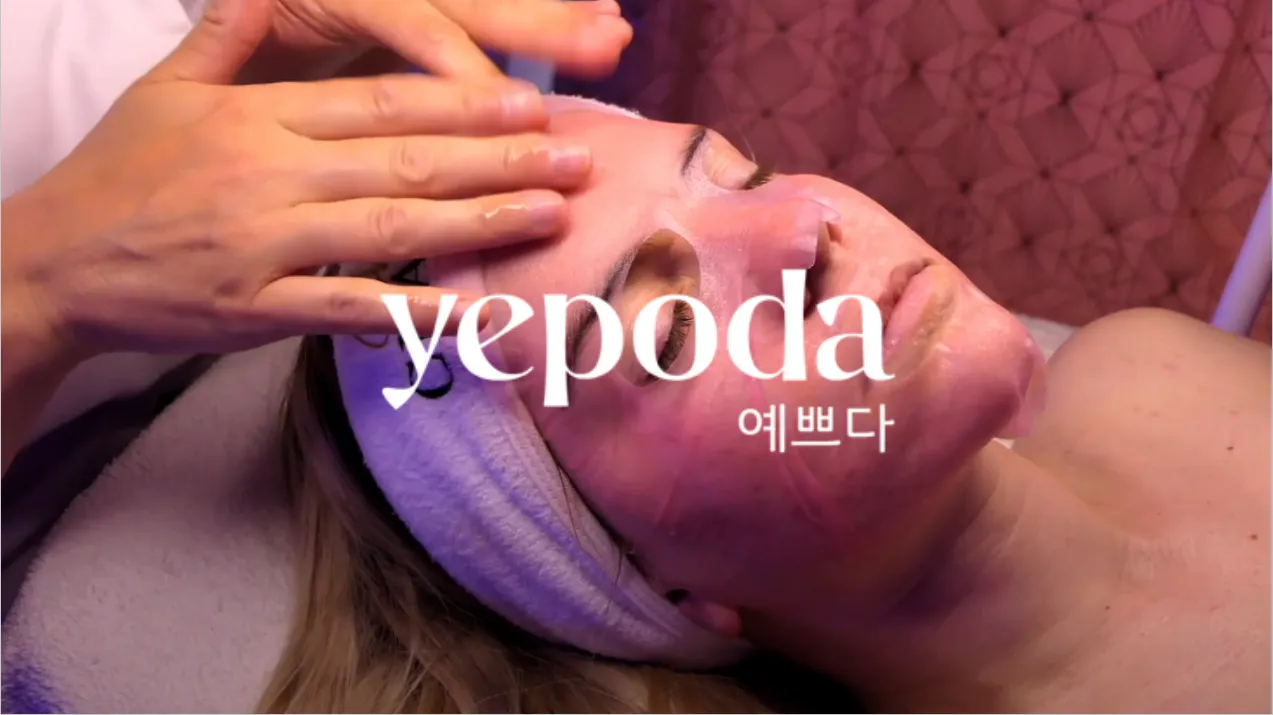 Personne recevant un massage du visage avec un bandeau blanc tenant les cheveux en arrière, avec le texte 'yepoda' superposé.