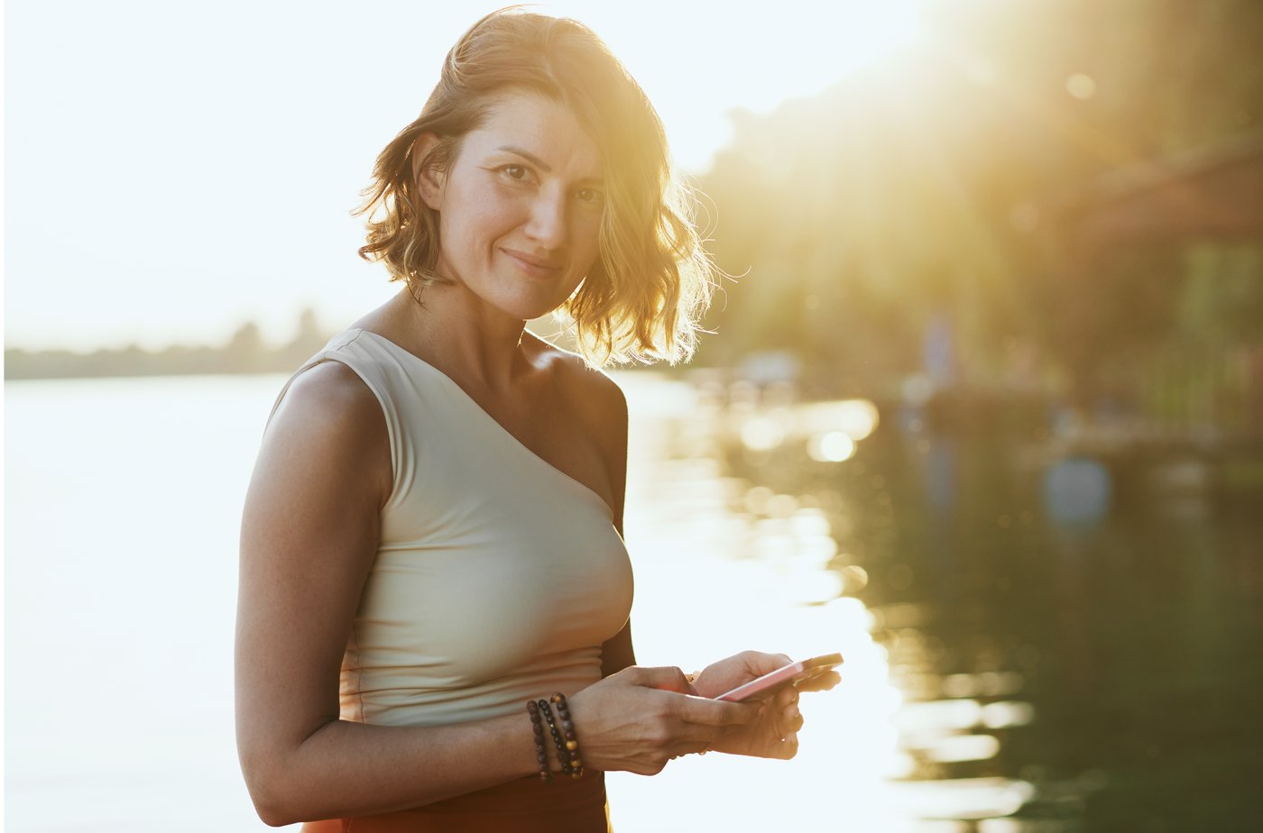 woman doing yoga at a dock by a lake