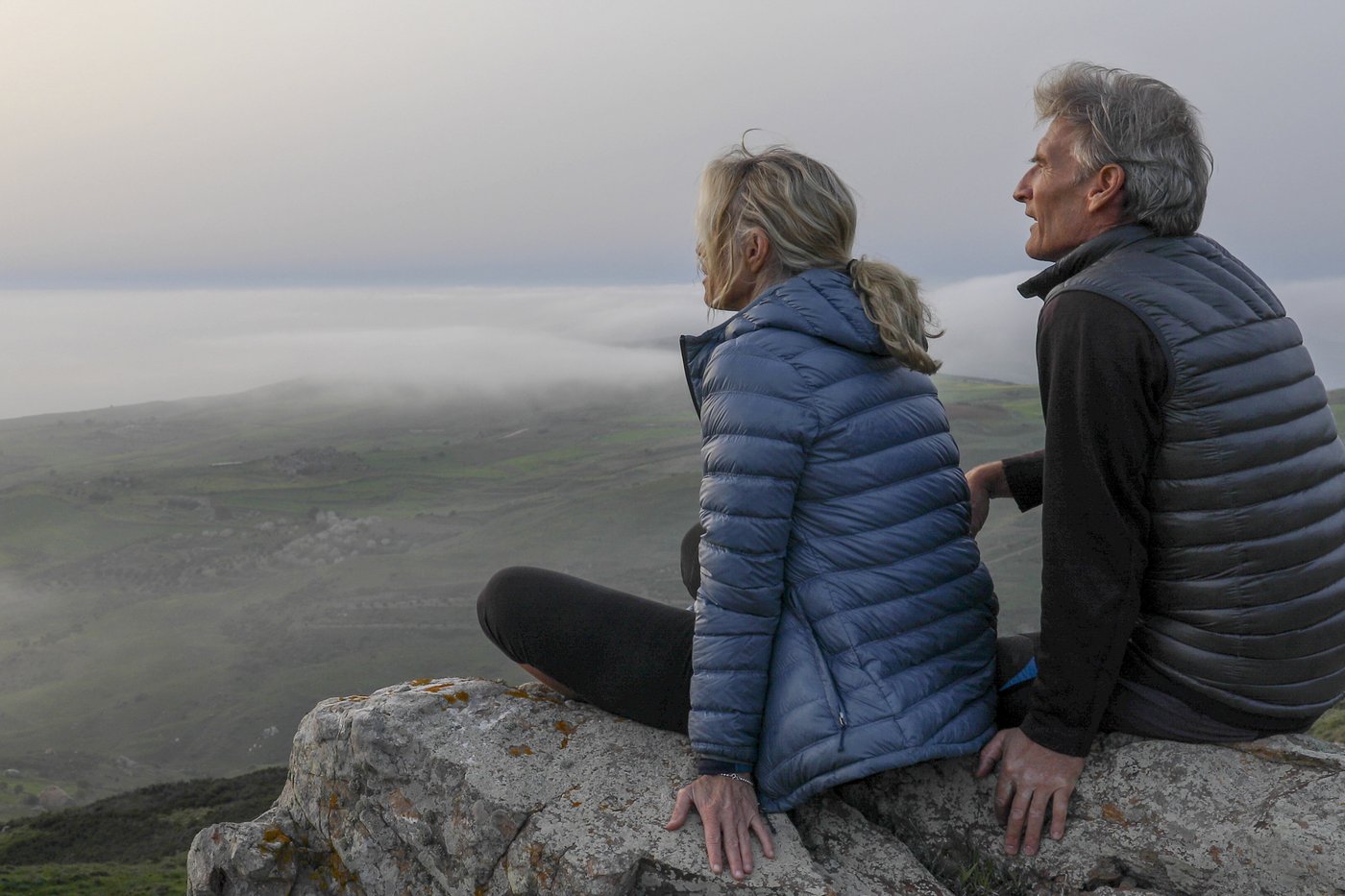 couple sitting down overlooking a valley